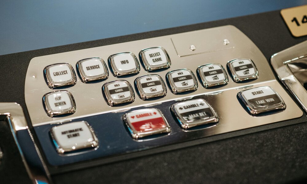 Slot machine control buttons showing paylines and info